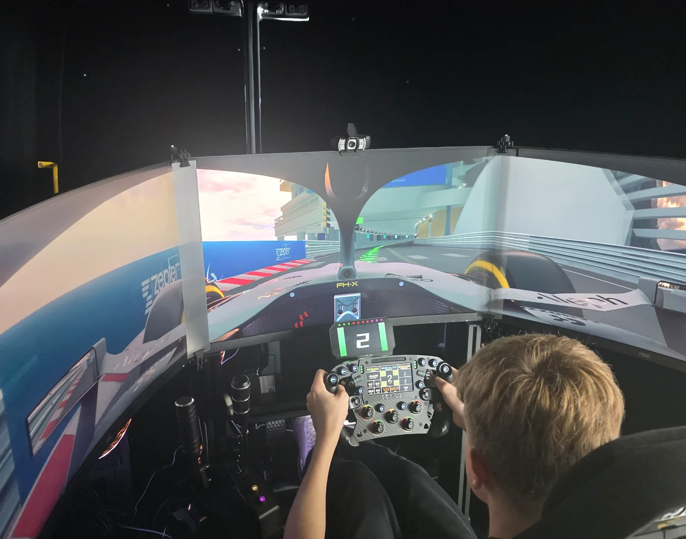 SIR Motorsport triple-screen racing simulator in use at an event