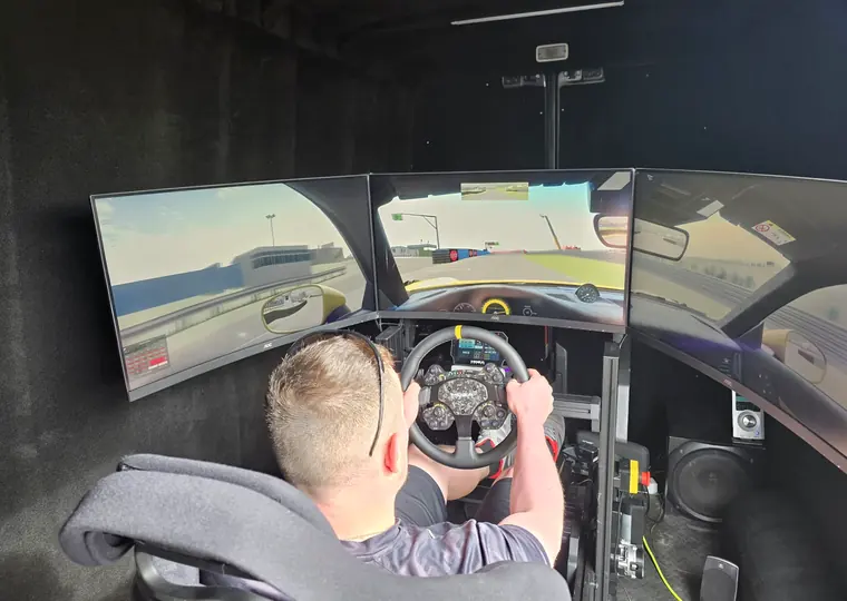 Driver competing inside the SIR Motorsport mobile racing simulator cockpit.