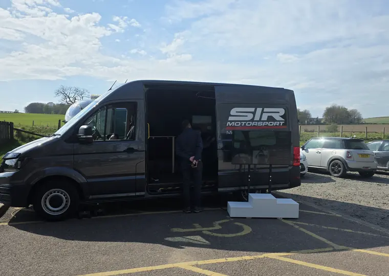 SIR Motorsport mobile racing simulator van set up with the side door open.
