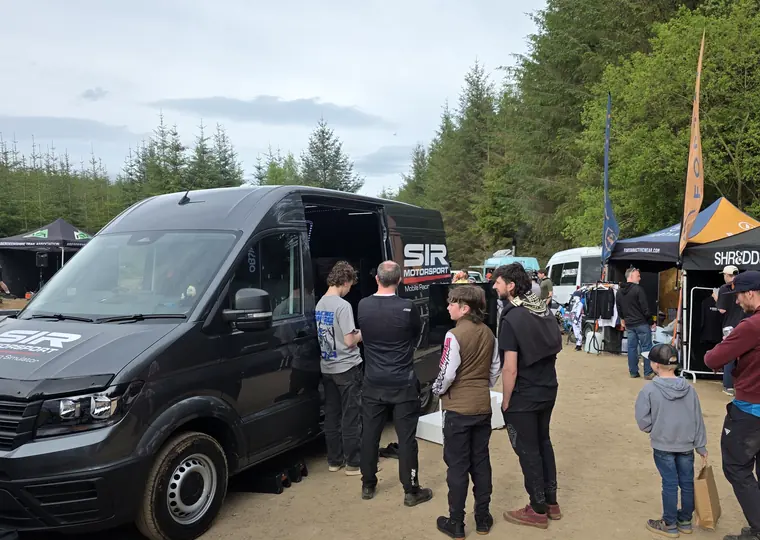 Crowd gathered around the SIR Motorsport mobile racing simulator at a recent event