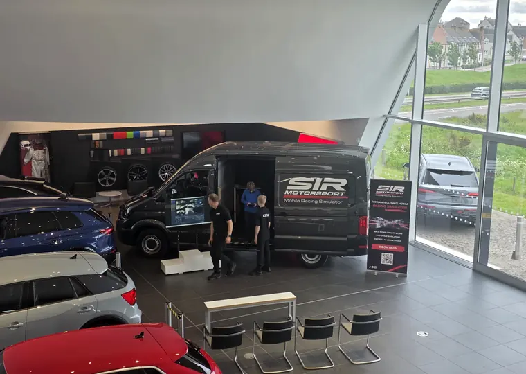 SIR Motorsport setup inside a premium venue surrounded by performance cars.