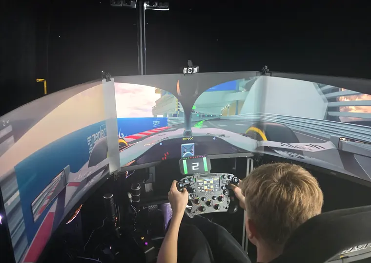 Triple-screen simulator cockpit during a SIR Motorsport event